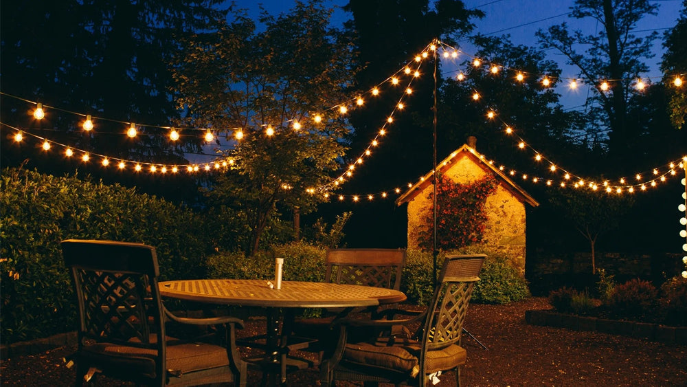 A cozy night scene with string lights hanging from an outdoor patio or deck